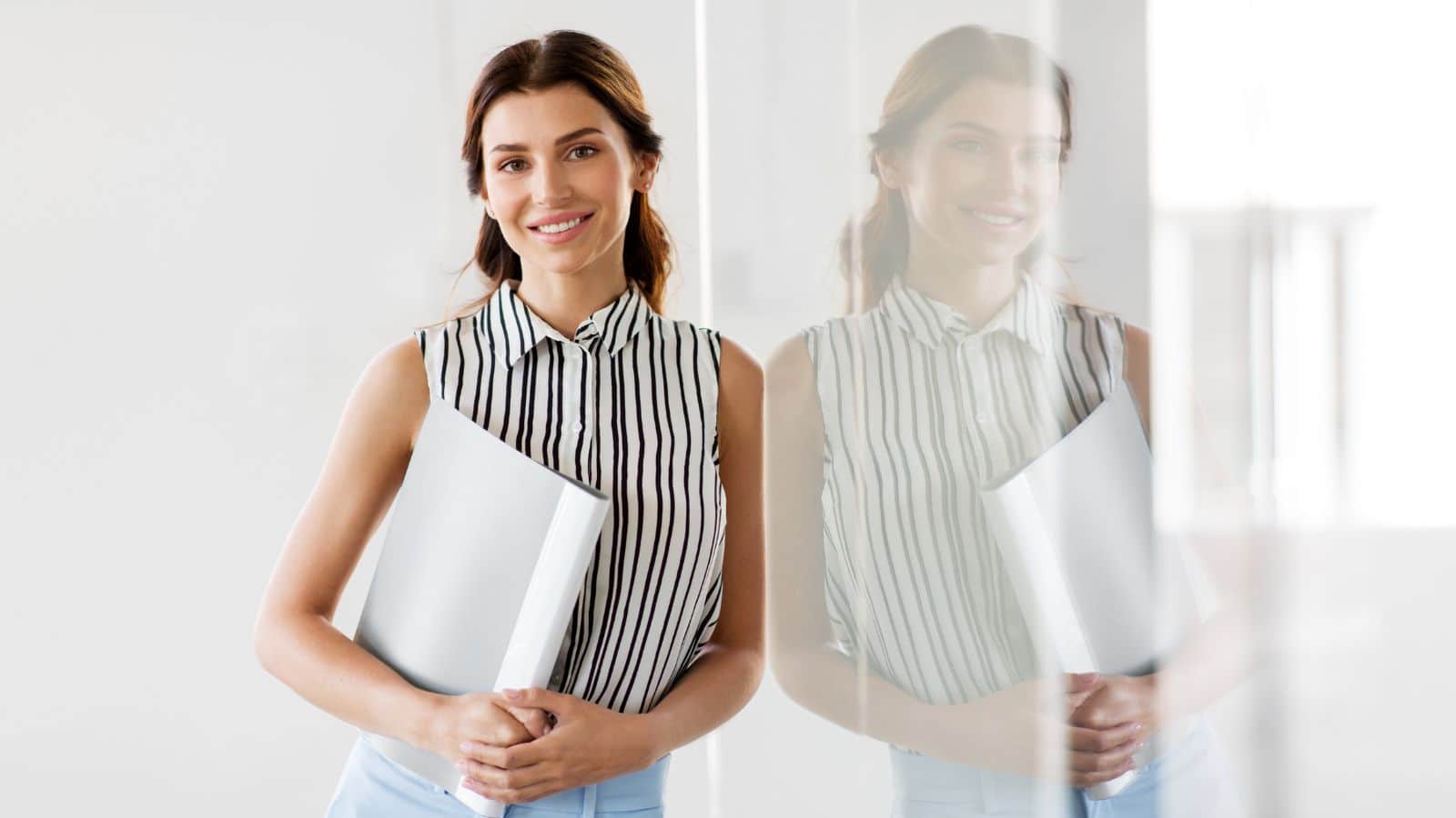 Woman smiling and holding and folder
