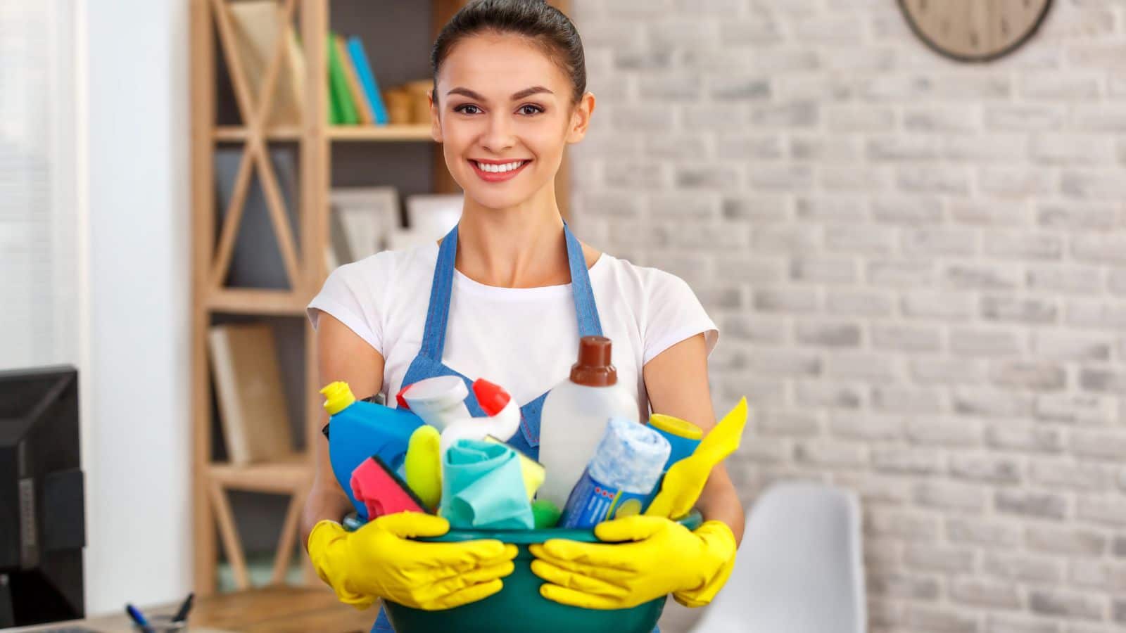 Woman holding a bucket of cleaning supplies