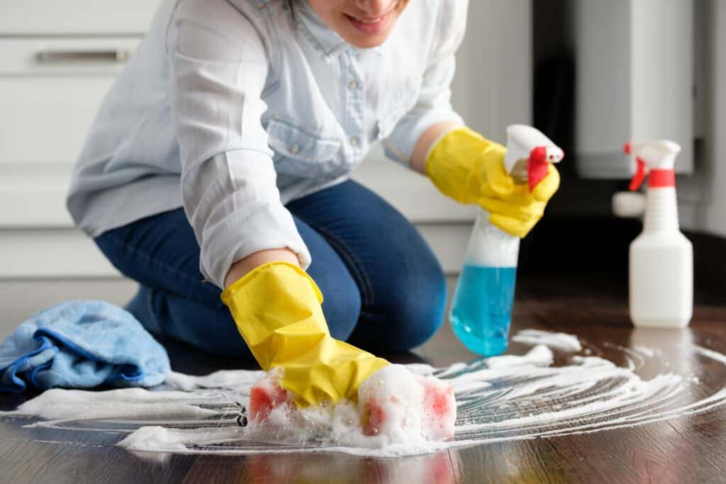 individual making a cleaning mistake on a wood floor